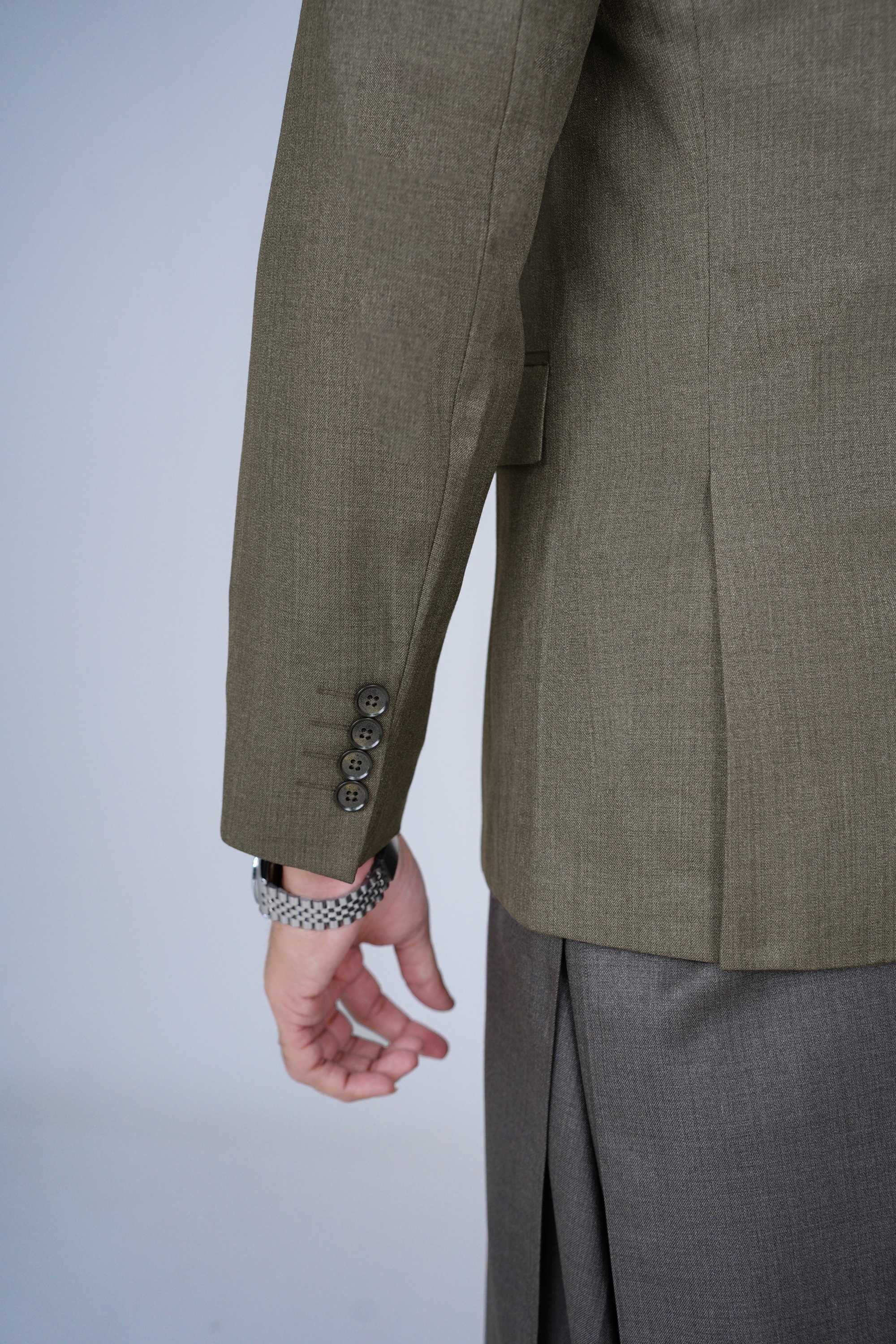 Stitched olive blazer made from premium imported suiting fabric with jetted pockets.