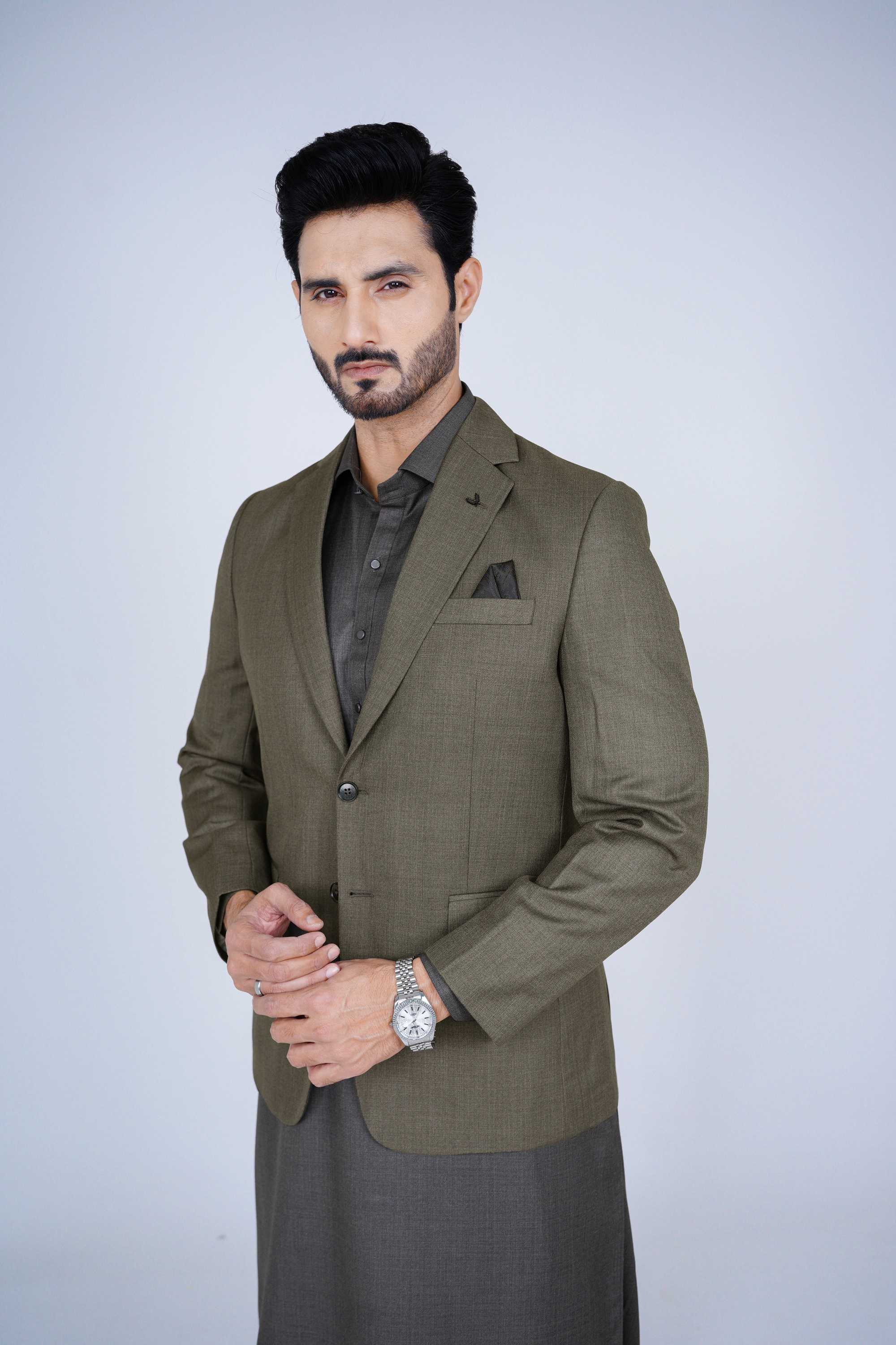 Stitched olive blazer made from premium imported suiting fabric with jetted pockets.